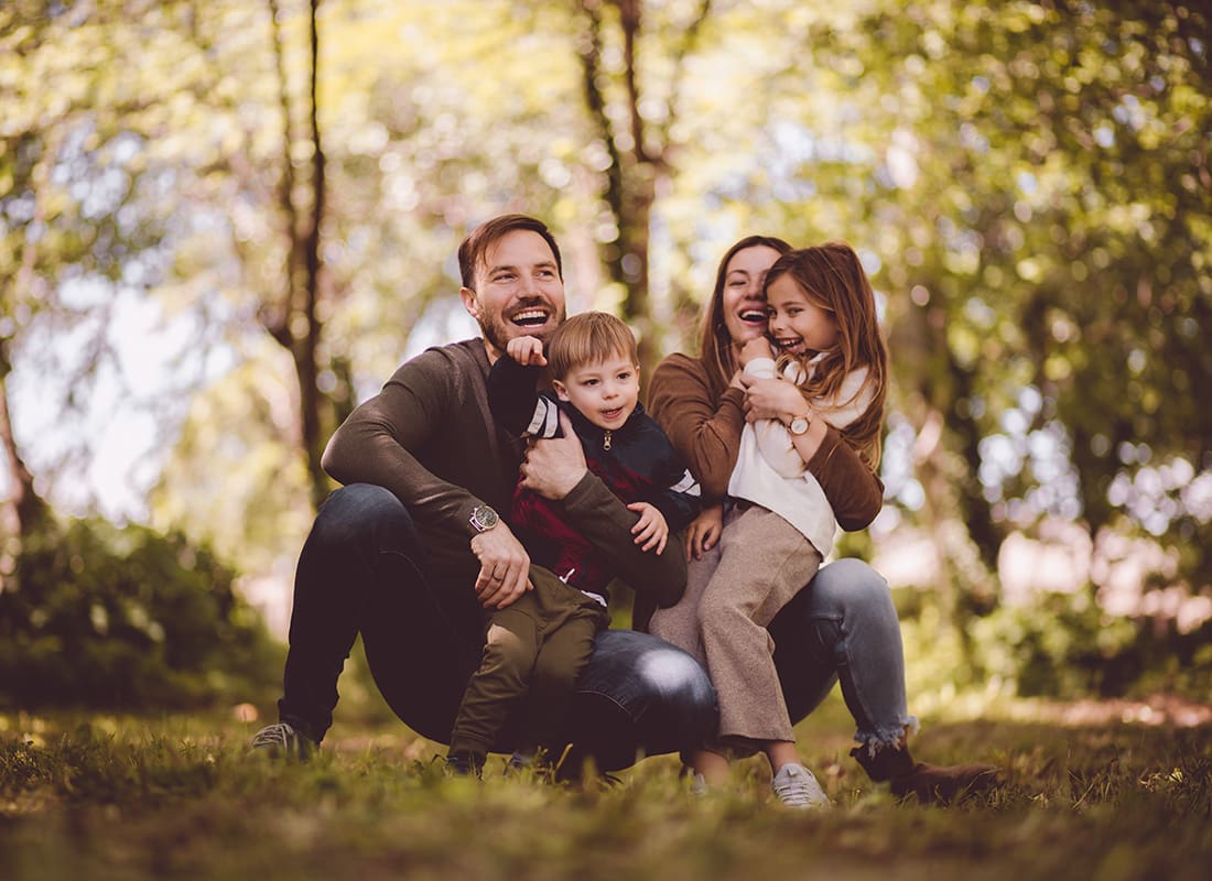 Personal Insurance - Portrait of a Family with Two Young Kids Having Fun Spending Time Together Outside on a Sunny Day