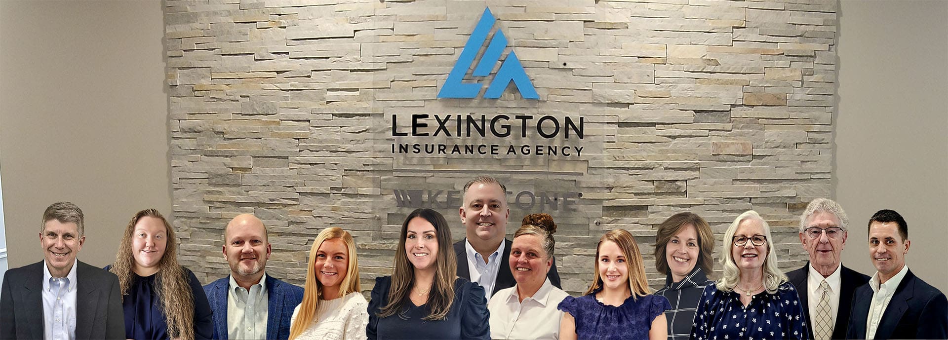About Our Agency - Lexington Insurance Team in Front of a Rock Wall in the Office with the Lexington Logo Updated